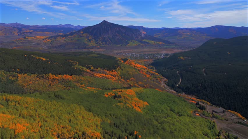 Crested Butte ski resort town drone aerial Mount Crested Butte Colorado autumn fall Gunnison national forest colorful Aspen Trees blue skies clouds Coal Creek Kebler Pass forward pan up motion