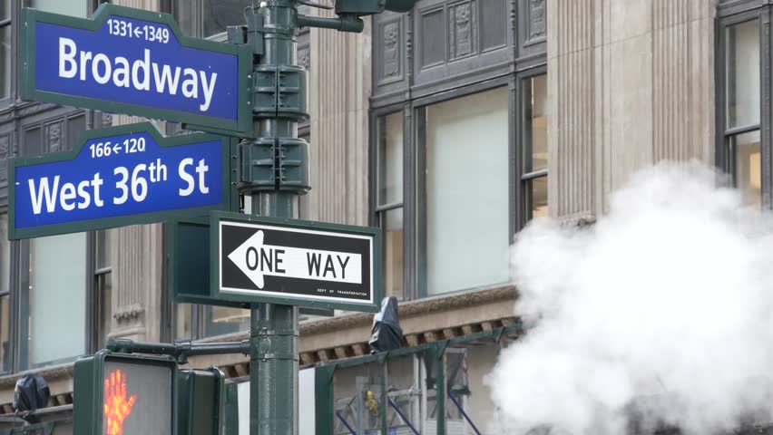 New York City Broadway and 36 street sign on Manhattan, United States. Urban road sign in american city. Traffic sign in Midtown of NYC. Building architecture, district near Herald Square. Hot steam.