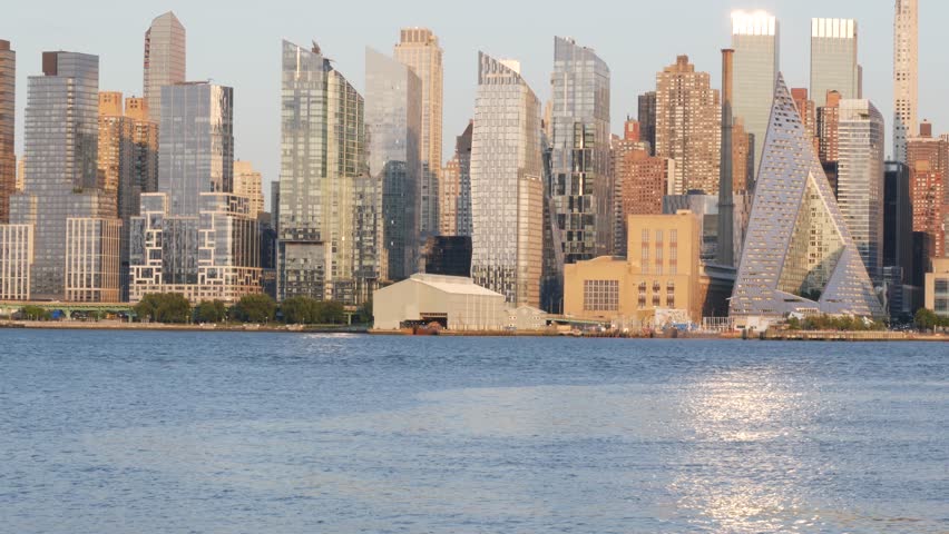 New York City Manhattan Midtown skyline, Hells kitchen from New Jersey, Weehawken Port Imperial, United States. Urban cityscape with skyscraper building, American architecture. Hudson River waterfront