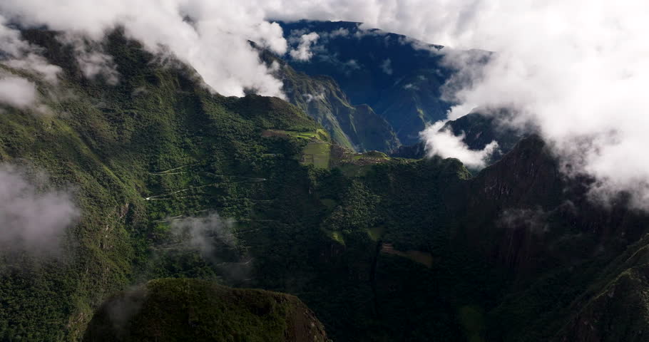 Famous Machu Picchu Inca citadel in Andes with mysterious mountain fog, aerial