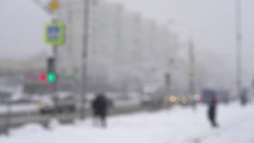 Blurred street of city with people and road with moving cars in snowfall in winter. Urban winter cityscape with snowstorm in defocus - Powered by Shutterstock - Get 15% off with code: PIKWIZARD15