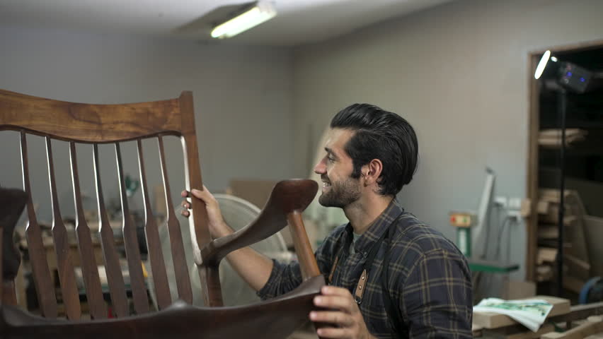 Carpenter is working at workshop. Small business and craft product.