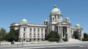 Scenic view of Neoclassical building of National Assembly of Serbia in Belgrade with green domes, classical columns, and bronze horseman sculptures captured on clear summer day - Powered by Shutterstock - Get 15% off with code: PIKWIZARD15