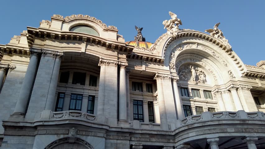 Cinematic view of the Palace of Fine Arts facade in Mexico City, showcasing Art Nouveau architecture.