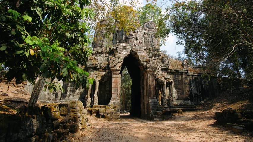 Ancient stone gate at the angkor thom temple complex in siem reap, cambodia. The camera moves towards the impressive ancient khmer ruins. Archeology concept