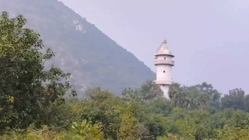 Footage of Hidden stone time tower in the forest india.