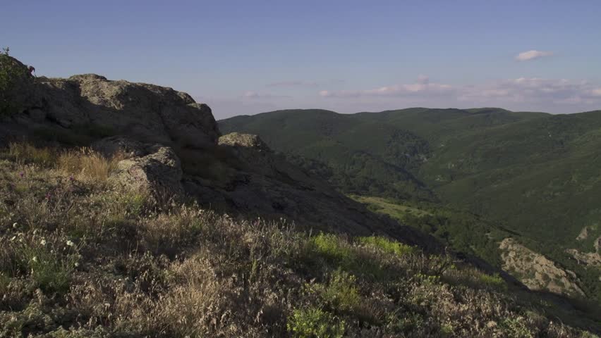 Pan shot on Stara planina and Sliven Valley. Tall mountains and green hills are shown from a high viewpoint. The view reveals valleys and distant horizons. The Balkan Mountains above Sliven town.