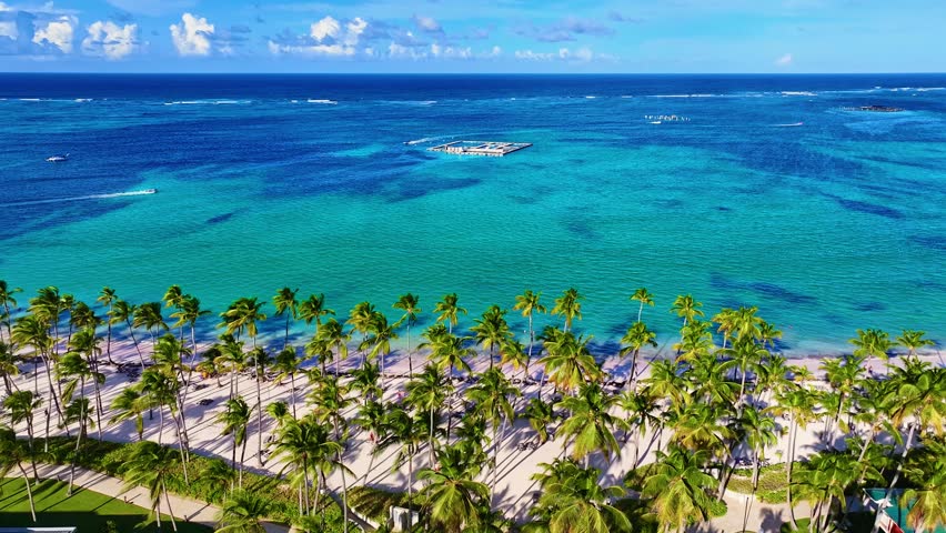 Relaxing on a palm-fringed beach in the Bahamas. A heavenly landscape of a resort-like sandy coastline. The best tropical beaches in the world. A heavenly landscape of a natural palm island.