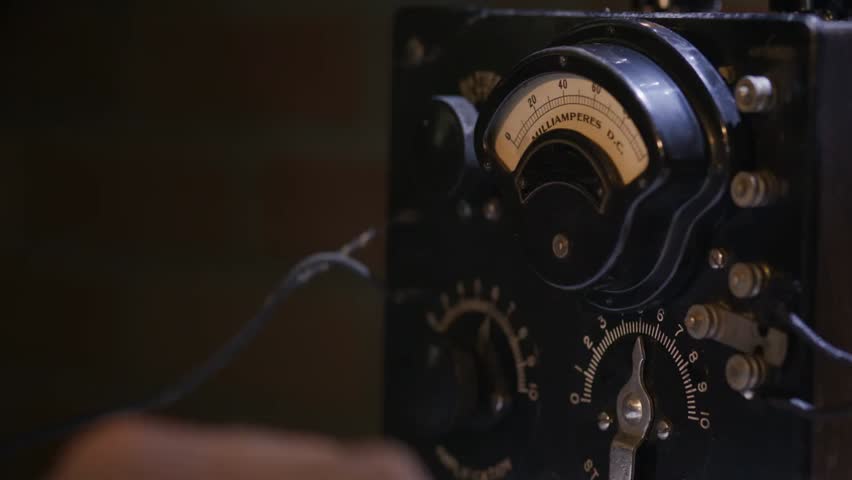 Close-up of radio transmitter dials and gauge indicators showing Morse code in action, illustrating vintage communication and radio technology.