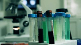 Scientific push-in from test tubes and microscope to a digital display of the coronavirus, illustrating research, virology, and medical science. - Powered by Shutterstock - Get 15% off with code: PIKWIZARD15