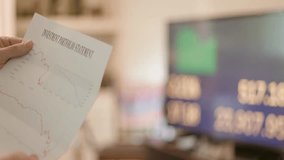 Man reviewing his crashed 401(k) investment statement during the COVID-19 pandemic. Stressful financial moment showing concern, loss, and economic uncertainty. - Powered by Shutterstock - Get 15% off with code: PIKWIZARD15