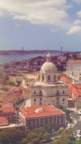 Lisbon skyline National Pantheon rising above Alfama quarter sunlit Tagus waterfront aerial perspective of Portuguese capital historic buildings old city town with maritime horizon traveling tourism