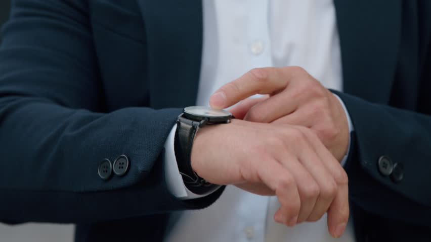 Closeup Asian Korean business man looking with wristwatch clock checking time in city Chinese Japanese middle-aged businessman boss company CEO agent check lateness waiting for corporate meeting taxi