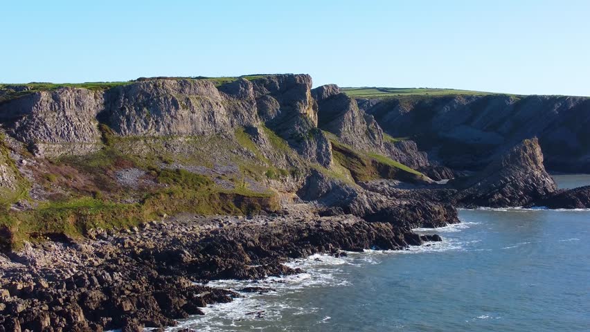 Sprawling Aerial Overview of South Wales Coastline with Different Rock Formations. Beautiful Welsh Gower Peninsula Coast. Travel Nature Drone Clip.