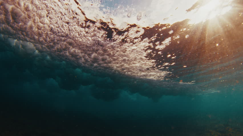Underwater view of the ocean wave breaking over the shore in the Maldives