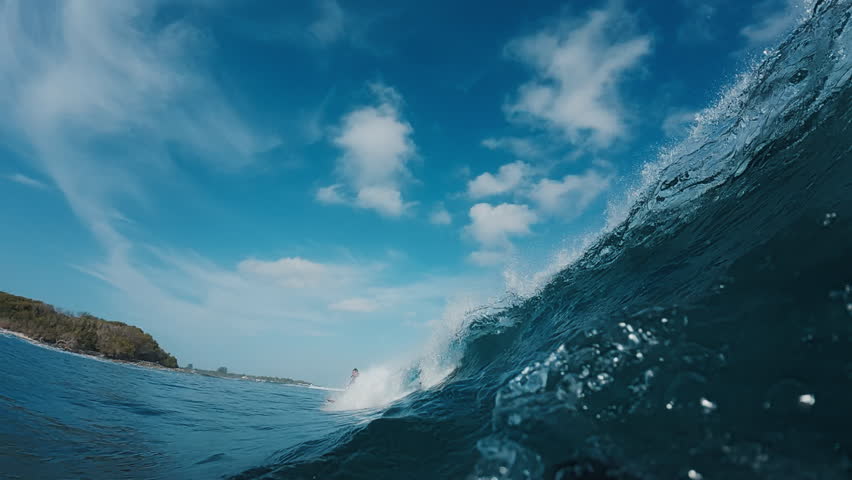 Underwater view of the ocean wave rolling and breaking over the shore in the Maldives