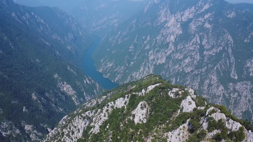 Stunning aerial panorama of the Drina River Gorge winding through steep, forested mountains in Tara National Park, a popular Serbian landmark