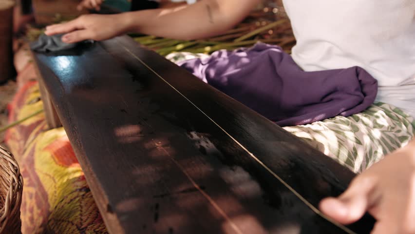 Woman extracting fibers from lotus stems to create a rare and luxurious silk thread, Cambodia, Siem Reap 