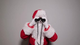 Surprised santa claus watching with binoculars - Powered by Shutterstock - Get 15% off with code: PIKWIZARD15
