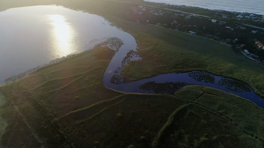 HUD appearing frame1, panels populating, sliding while readouts updating, tracking coastal river. Overlay, wireframe, dataviz, dashboard, parallax, analytics, aerial
