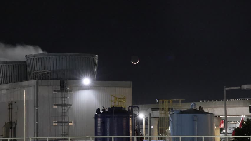 steam smoke rising from large electricity power generator station plant at airport at night (plume smoking electrical transformer factory industrial generation) new york city usa 