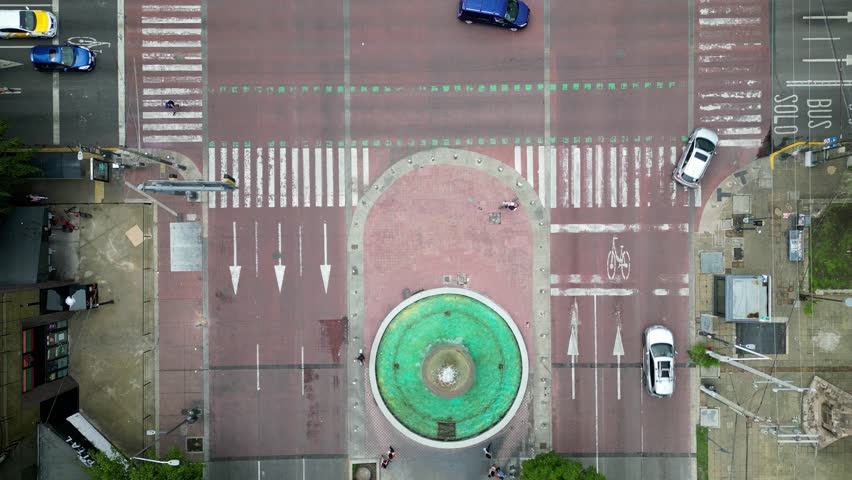 Aerial video panning over Avenida Chapultepec with traffic, fountains and crosswalks in Guadalajara, Mexico