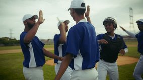 A batter hits the ball during a baseball game, leading to an energetic team celebration. Players high-five and hug, showing unity and joy on the field after a successful play. - Powered by Shutterstock - Get 15% off with code: PIKWIZARD15