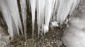 Many crowded icicles cover a natural frozen waterfall in cold air during winter. Winter conditions create dense ice formations as water freezes into clustered shapes. - Powered by Shutterstock - Get 15% off with code: PIKWIZARD15