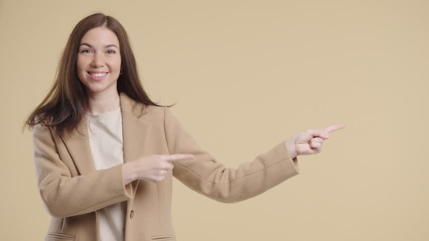 Happy Smiling Woman Presenting And Showing Something Isolated On Beige