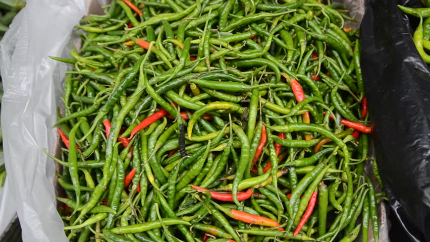 Bird's eye chilies or Thai chili. Fresh green chili peppers for sale on the market. 