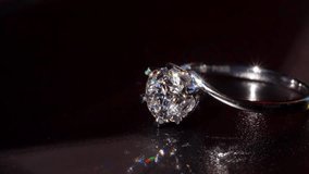 Brilliant Diamond Gold Ring Shines in Dramatic Macro Close-Up. Revealing Its Sparkling Facets Refined Metalwork. Luxurious Blend of Artistry, Elegance and Timeless Beauty In Every Glowing Detail 4k - Powered by Shutterstock - Get 15% off with code: PIKWIZARD15