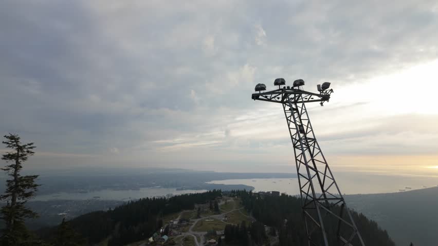 Gimbal wide booming down shot of the summit of Grouse Mountain during the fall season in North Vancouver, British Columbia, Canada. 4K