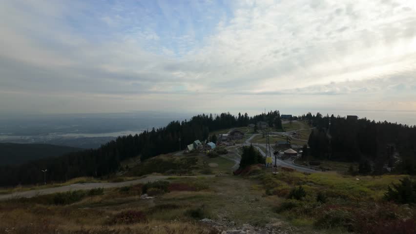 Gimbal wide panning shot of the Grouse Mountain summit during autumn in North Vancouver, British Columbia, Canada. 4K