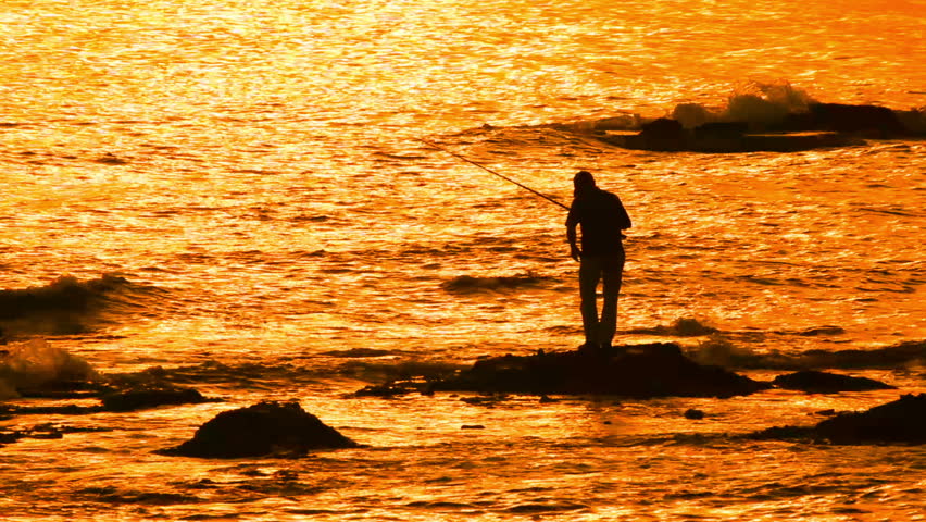 fisherman with spinning silhouette at sea sunset