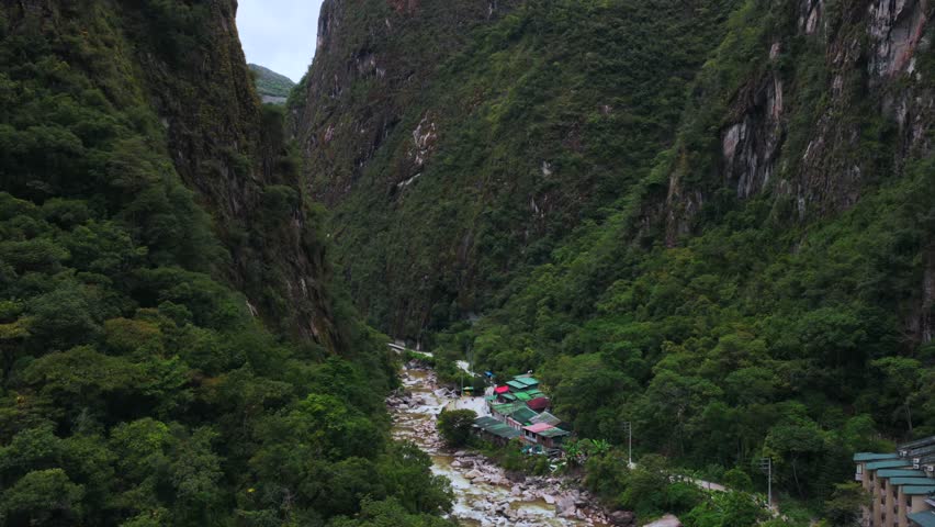 Aguas Calientes Machu Picchu dry rainy season cloudy afternoon Peru aerial drone Peruvian Andes Mountains Urabumba river jungle lower highlands Inca trail citadel nature landscape buildings forward
