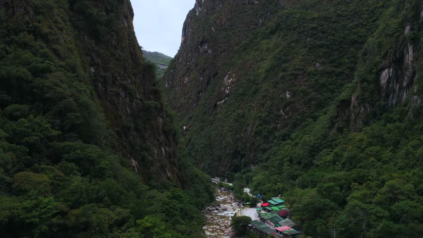 Aguas Calientes Machu Picchu dry rainy season cloudy afternoon Peru aerial drone Peruvian Andes Mountains Urabumba river jungle lower highlands Inca trail citadel landscape buildings circle right