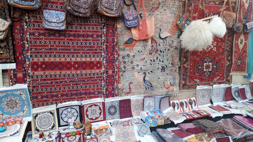 Traditional colorful patterns on hand woven rugs, covers and bags in Azerbaijan.