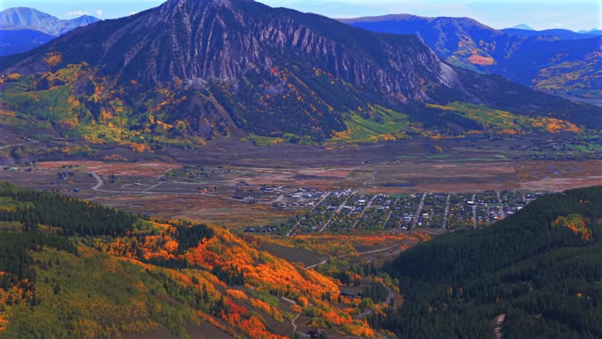 Crested Butte ski resort town drone aerial Mount Crested Butte Colorado autumn fall Elk Range Rocky Mountains quaking colorful Aspen Trees blue skies clouds Coal Creek Kebler Pass forward pan up