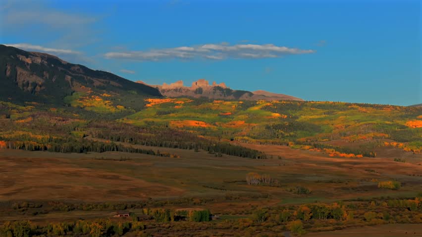 Scenic Fall autumn drive Mill Creek Ranch farm land Ohio Creek Valley Pass near Crested Butte Colorado Gunnison Country aerial drone Mill Castle rock landmark feature colorful Aspen trees upwards
