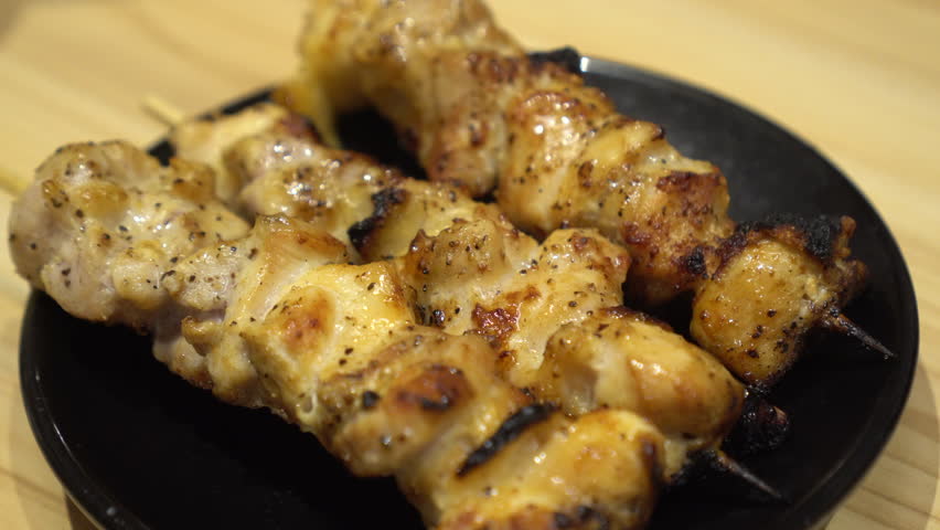 Hand picking grilled chicken skewer Japanese yakitori izakaya drinking food