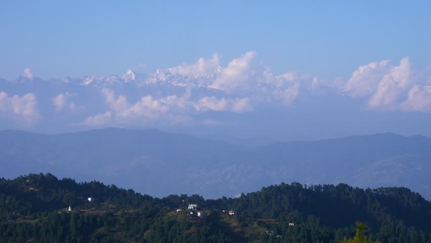 Beautiful scenic view of hills and mountains, green hills and white mountains coming together.