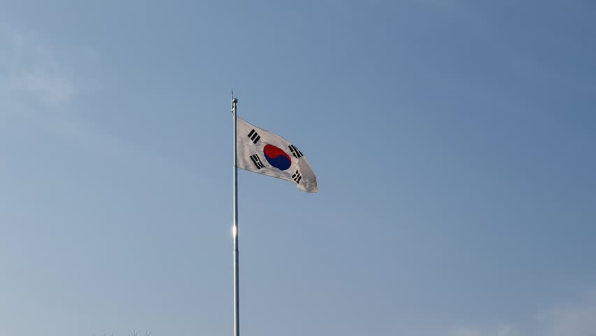 South Korean National Flag Taegeukgi Fluttering in Strong Wind Against Dramatic Sky
