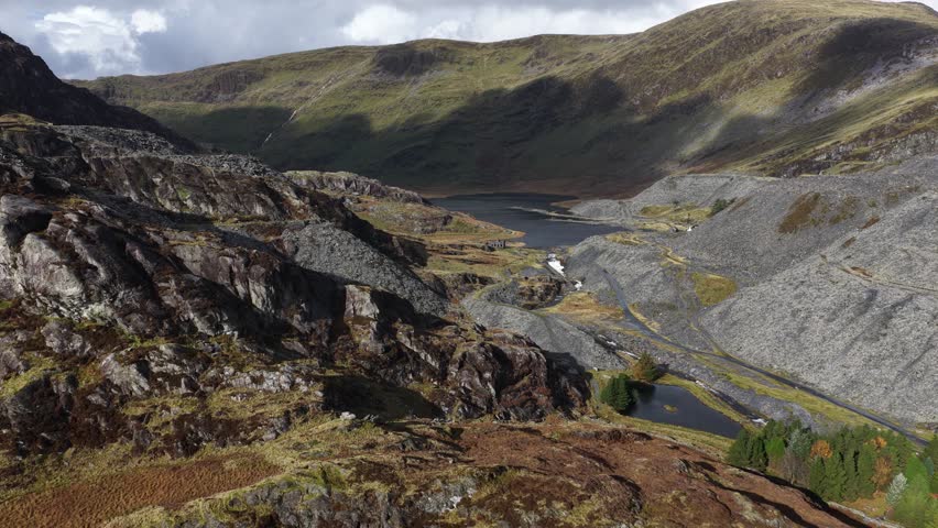Aerial video of the rugged mountain landscape around Llyn Cwmorthin in Snowdonia National Park, showcasing dramatic Welsh terrain, natural wilderness, and scenic highland beauty.
