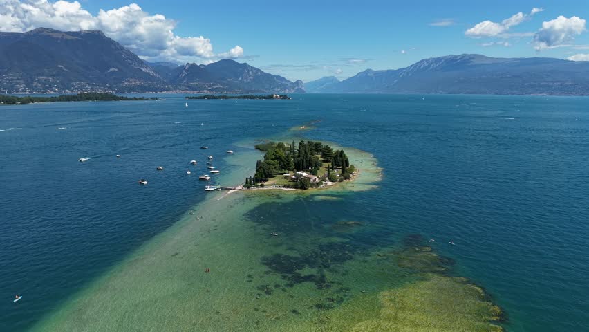 Summer aerial view of Isola di San Biagio, Lake Garda, Italy, showing turquoise waters and island views.