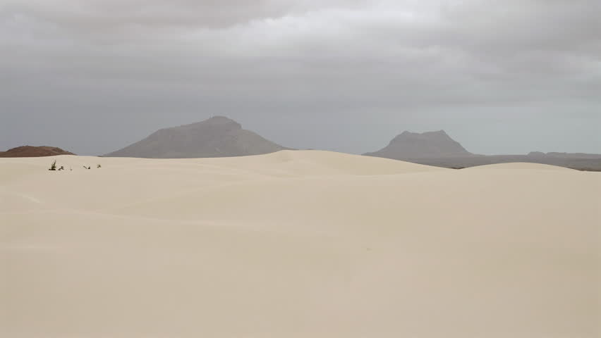 Nice view of sand dunes in Viana desert close up at overcast day, background volcanic mountains, Boa vista , Cape Verde.