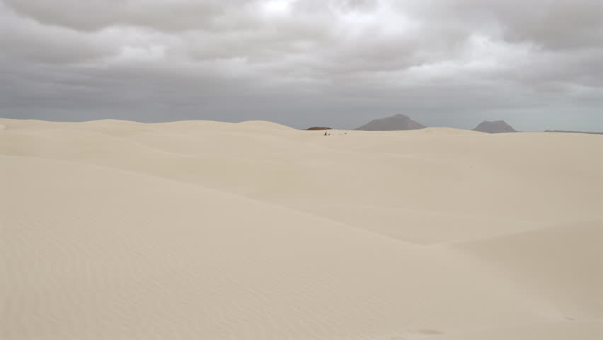 Amazing sand dunes in Viana desert and background mountains at overcast day, Boa vista , Cape Verde.