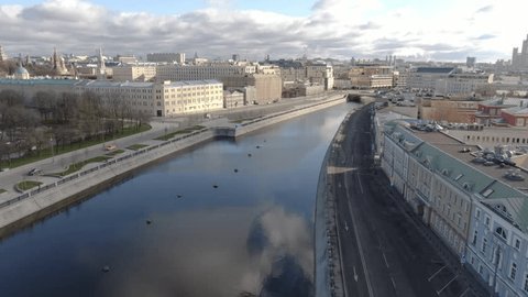 Backward Descending Drone View along Quiet Riverside