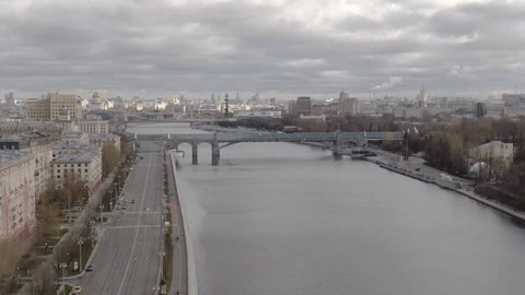 Aerial Sideways Motion over Urban River Bridge