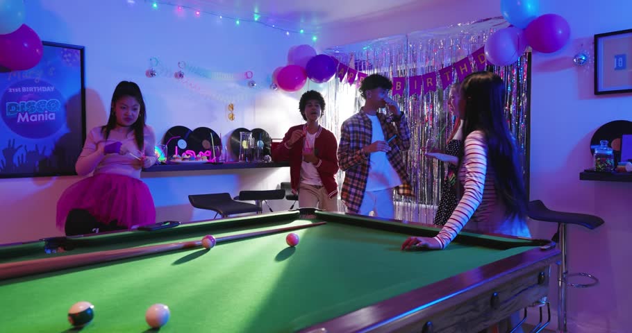 Striped woman nudging pool balls, group celebrating birthday, animated letters drifting across lens. Celebration, friends, decor, balloons, disco, vibrant, table
