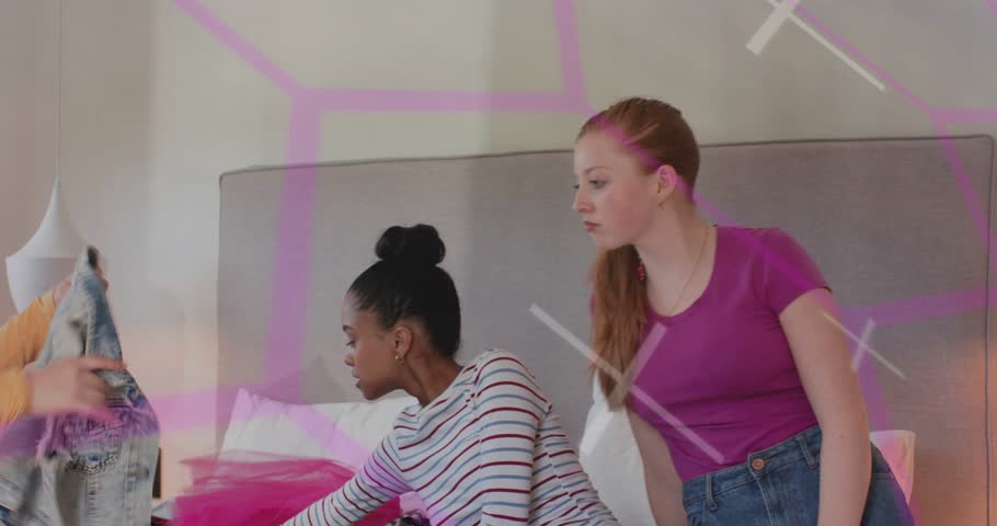 Two women on bed reaching plaid holding spots styling outfits while neon overlay pulsing over them. Duo, friends, polkadot, bedroom, fashion, lookbook, futuristic